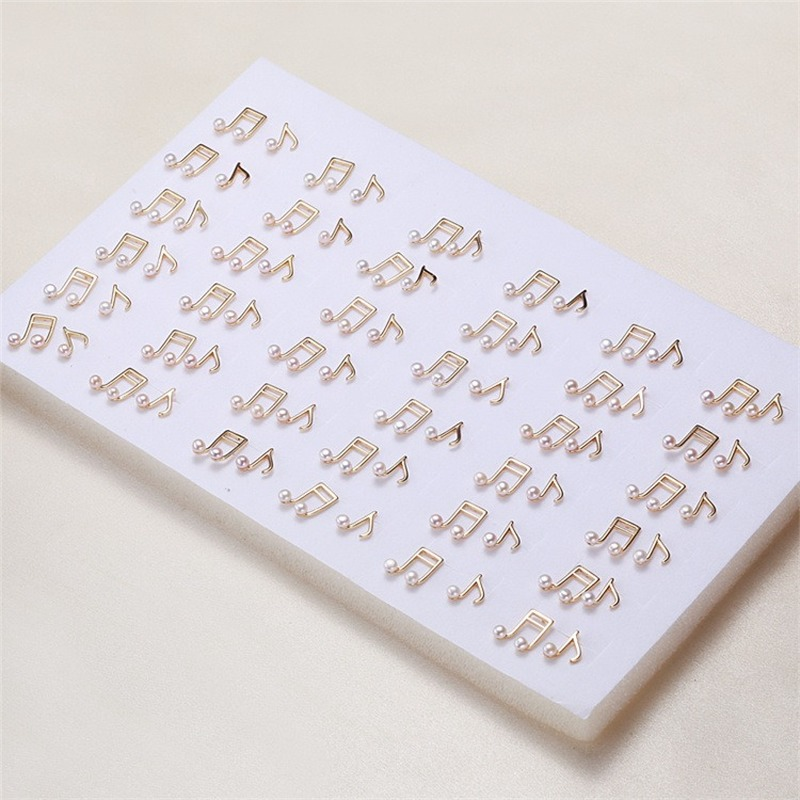 Aretes de perlas cultivadas de agua dulce estilo notación musical en oro de 14 k sobre plata de ley