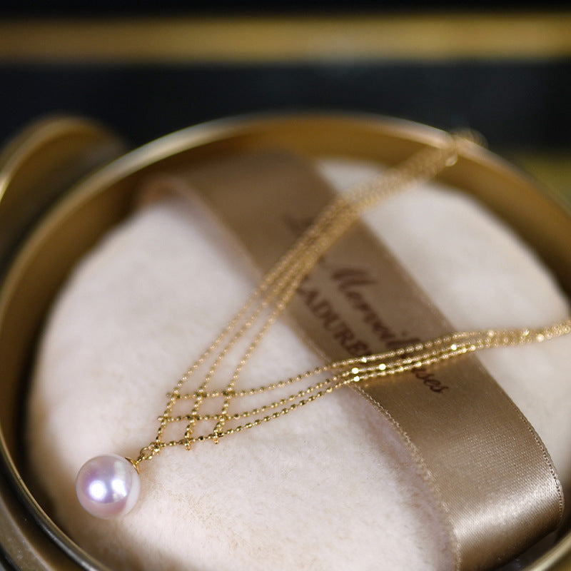 multistrand gold necklace with pearl