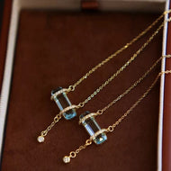 Gold necklace with blue gemstones in a jewelry box